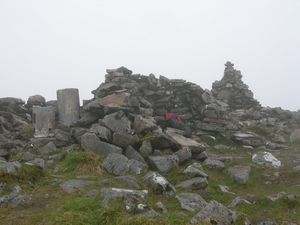 Trig point, windbreak and cairn at the summit